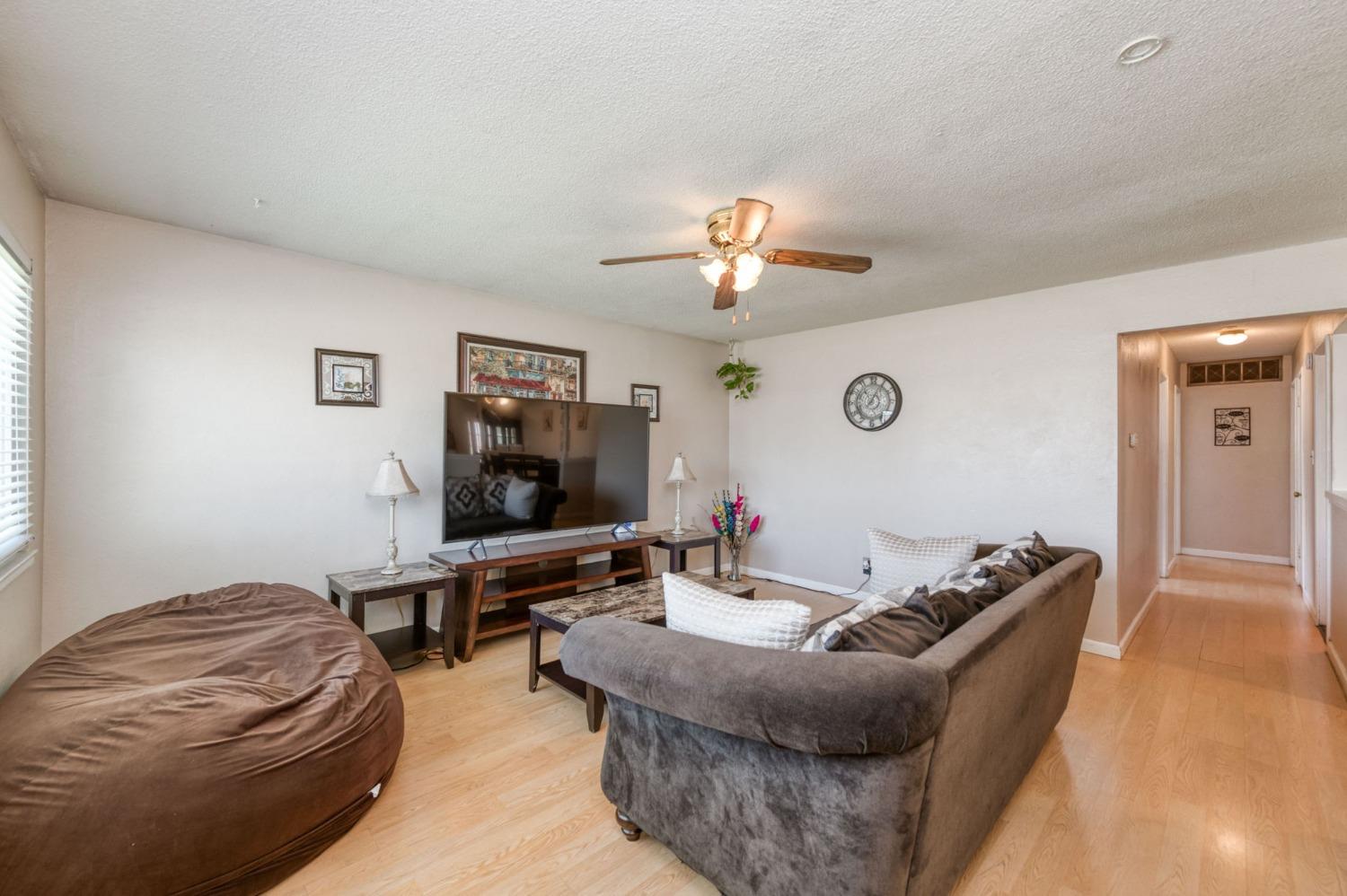1325 Terry Avenue Clovis, CA 93612 - Photo 4 of 28 a living room with furniture and a flat screen tv