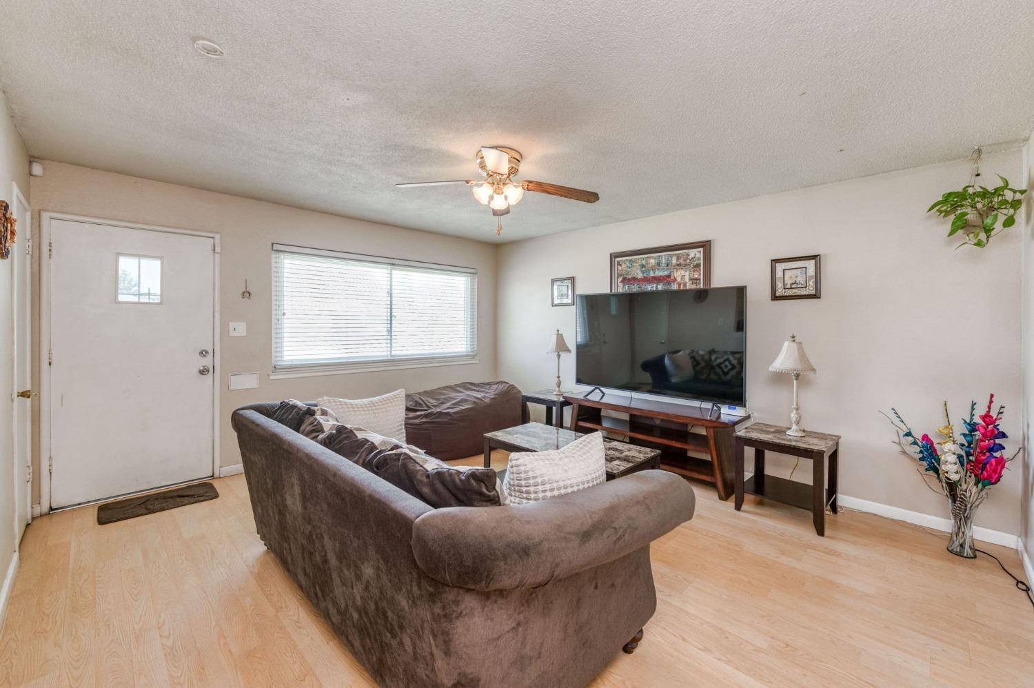 1325 Terry Avenue Clovis, CA 93612 - Photo 5 of 28 a living room with furniture and a flat screen tv
