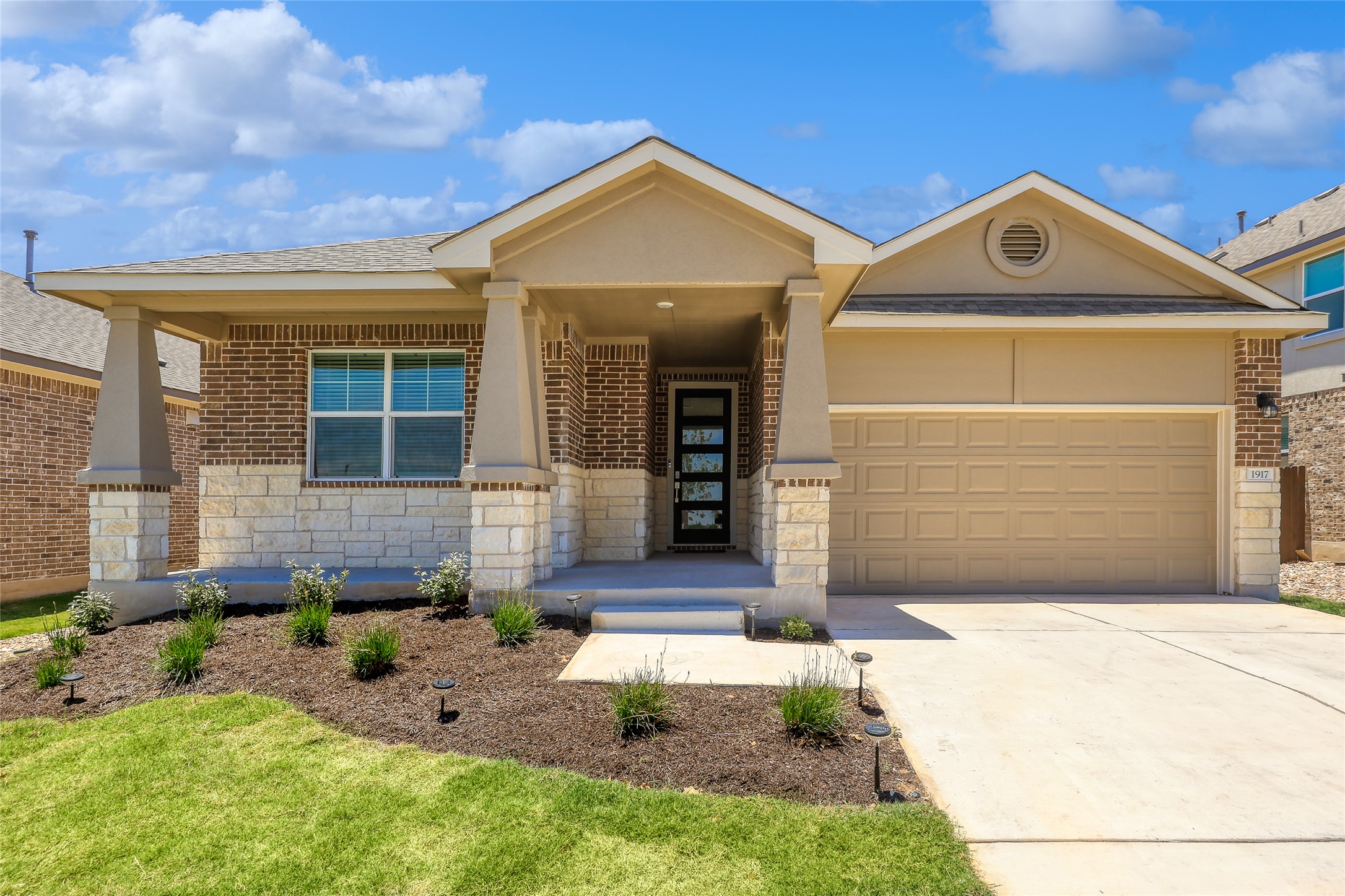1917 Centerline Lane Georgetown, TX 78628 - Photo 1 of 29 A welcoming facade features a blend of brick and stone, leading to a modern entry.