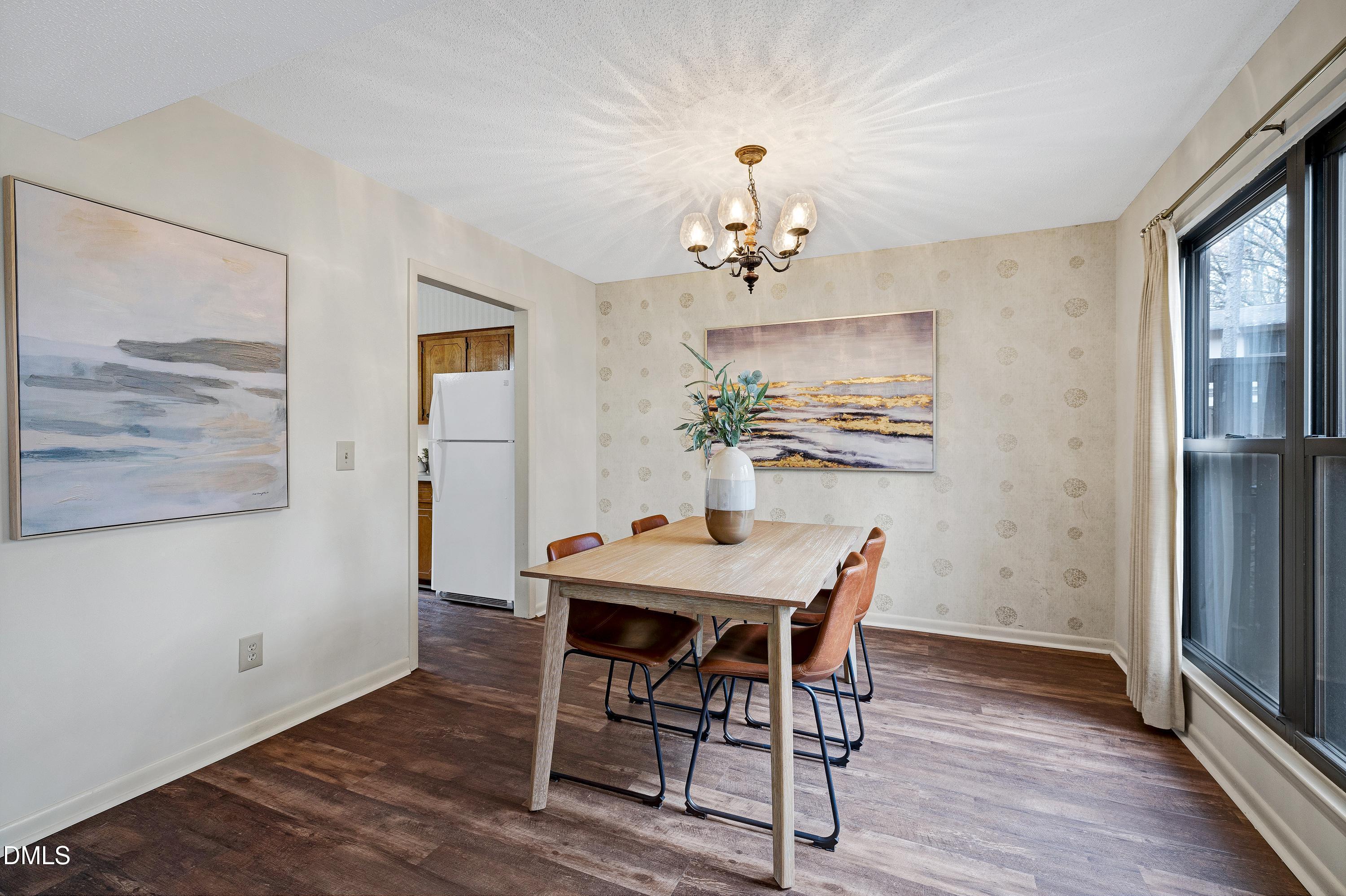 3905 Wendy Lane Raleigh, NC 27606 - Photo 13 of 42 a view of a dining room with furniture wooden floor and a chandelier