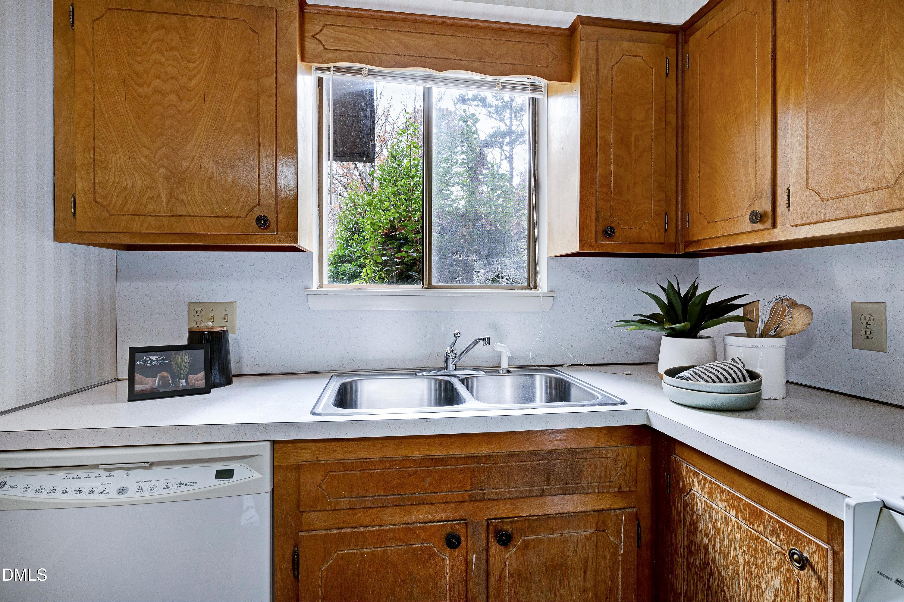 3905 Wendy Lane Raleigh, NC 27606 - Photo 16 of 42 a kitchen with stainless steel appliances a sink a potted plant and a window