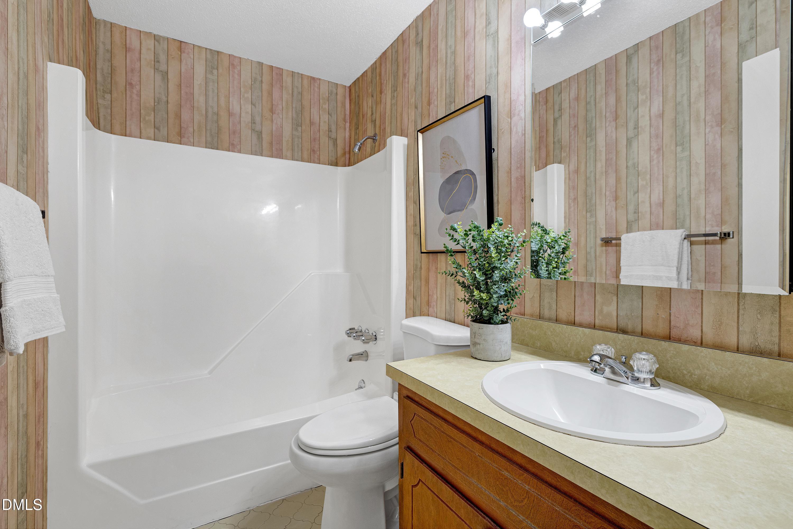 3905 Wendy Lane Raleigh, NC 27606 - Photo 25 of 42 a bathroom with a sink a toilet and shower