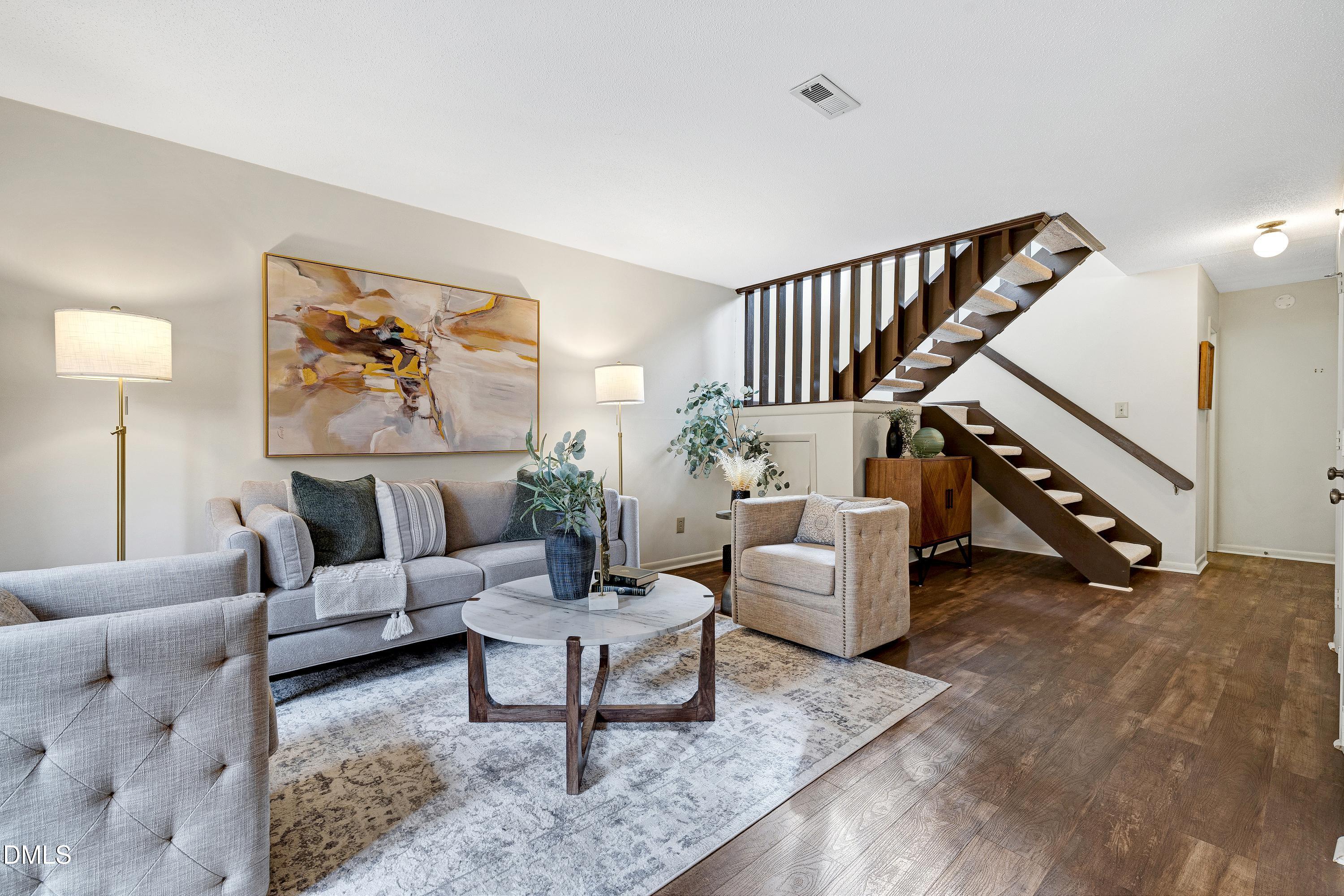 3905 Wendy Lane Raleigh, NC 27606 - Photo 6 of 42 a living room with furniture and stairs