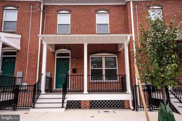 a kitchen with stainless steel appliances granite countertop a refrigerator a stove a sink and a microwave