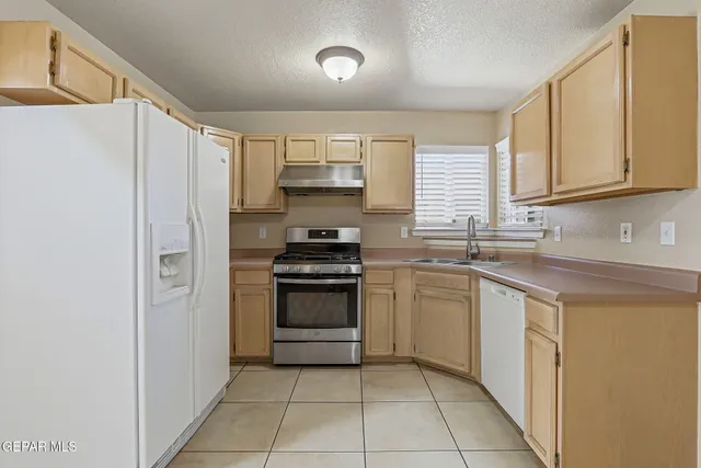 a kitchen with a sink appliances and cabinets