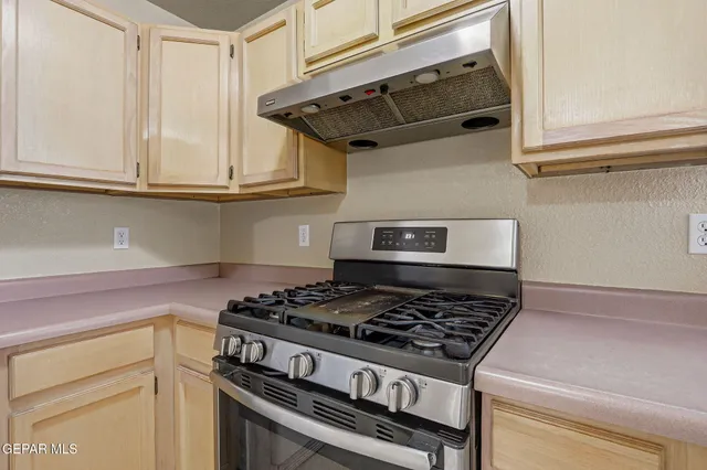 a kitchen with stainless steel appliances granite countertop a stove and a microwave