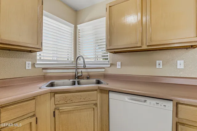 a kitchen with stainless steel appliances granite countertop a sink and a cabinets