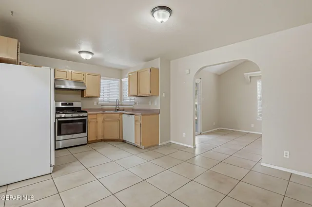 a kitchen with cabinets and white appliances