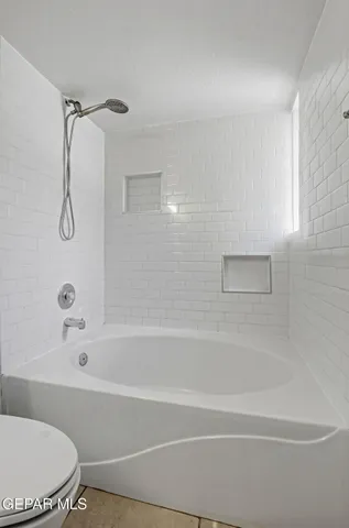 a bathroom with a bathtub and a shower