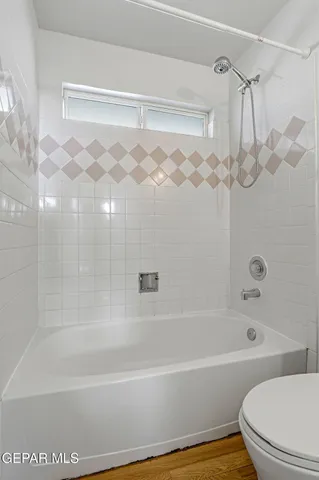 a bathroom with a shower curtain and a bathtub