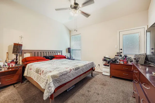 a bedroom with bed and window