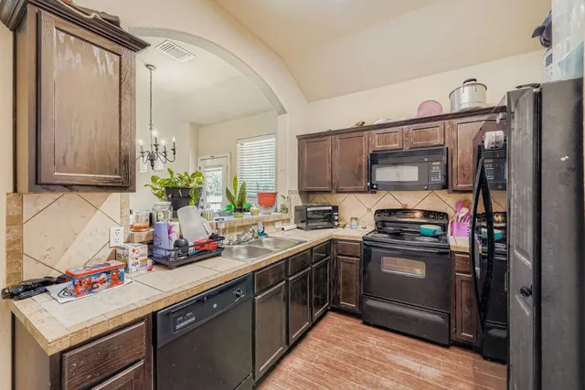 a kitchen with a sink stove and refrigerator