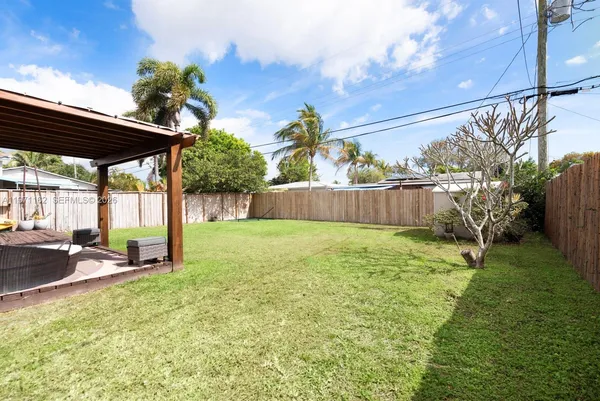 a view of a house with a yard and sitting area