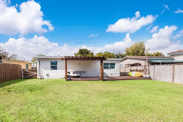 a view of a balcony with chairs and a potted plant