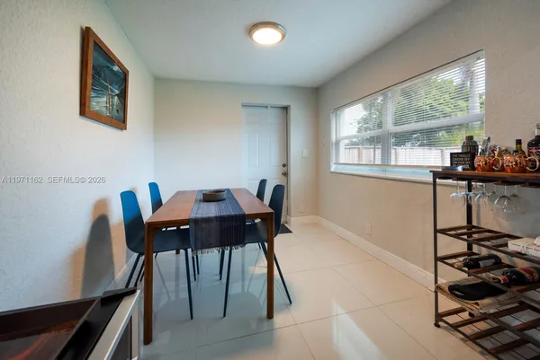a kitchen with granite countertop a sink a microwave a refrigerator and cabinets