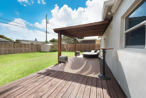 a backyard of a house with table and chairs