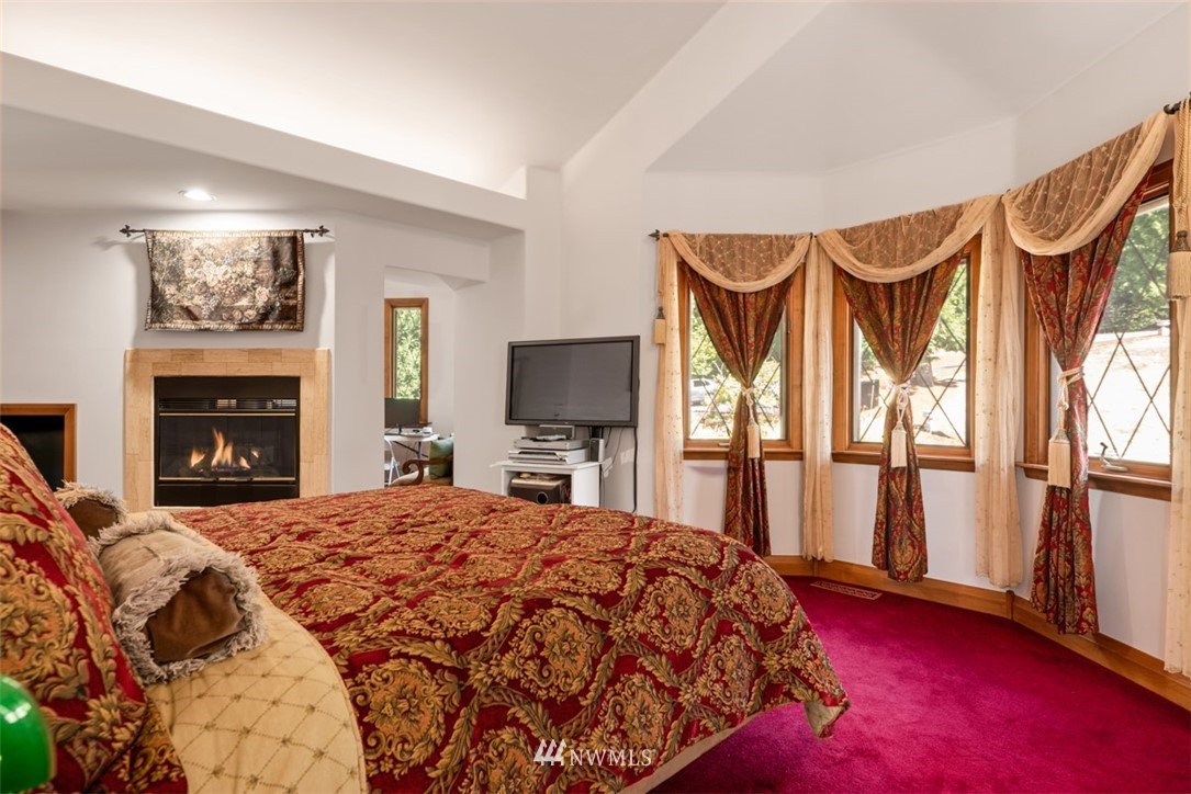 21632 High Rock Road Monroe, WA 98272 - Photo 5 of 40 a bedroom with a bed and a flat screen tv