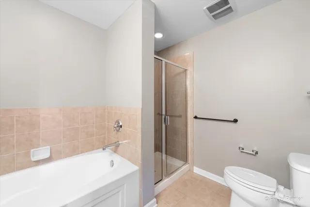 a bathroom with a tub a double vanity sink and a mirror