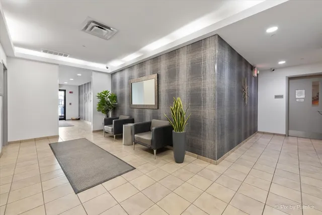 a lobby with furniture and potted plant