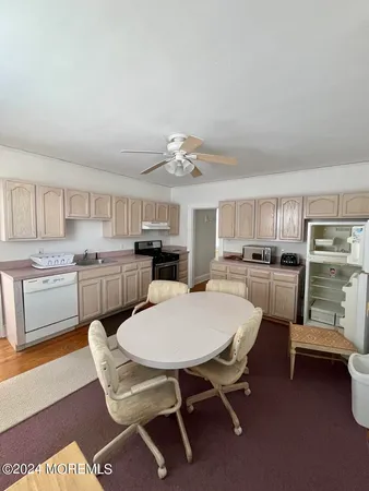 a kitchen with a table chairs microwave and cabinets