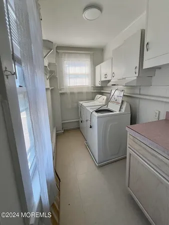 a utility room with sink dryer and washer