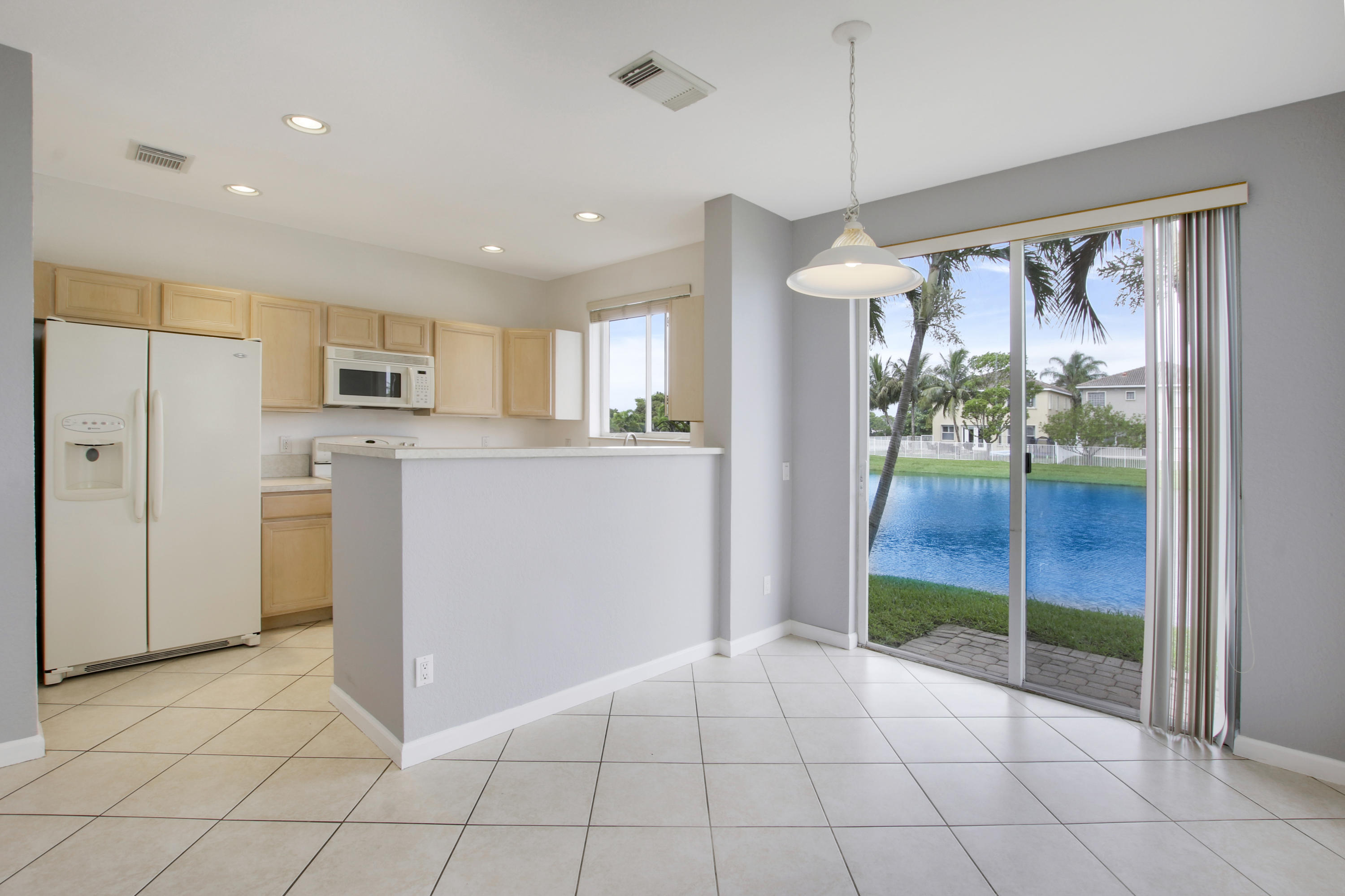 3111 Laurel Ridge Circle Riviera Beach, FL 33404 - Photo 11 of 30 Dining with lake views