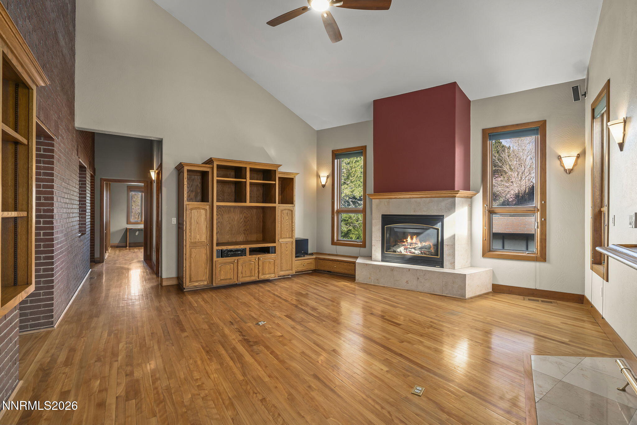 2425 Foley Way Reno, NV 89509 - Photo 14 of 73 a view of a livingroom with a fireplace a chandelier and wooden floor