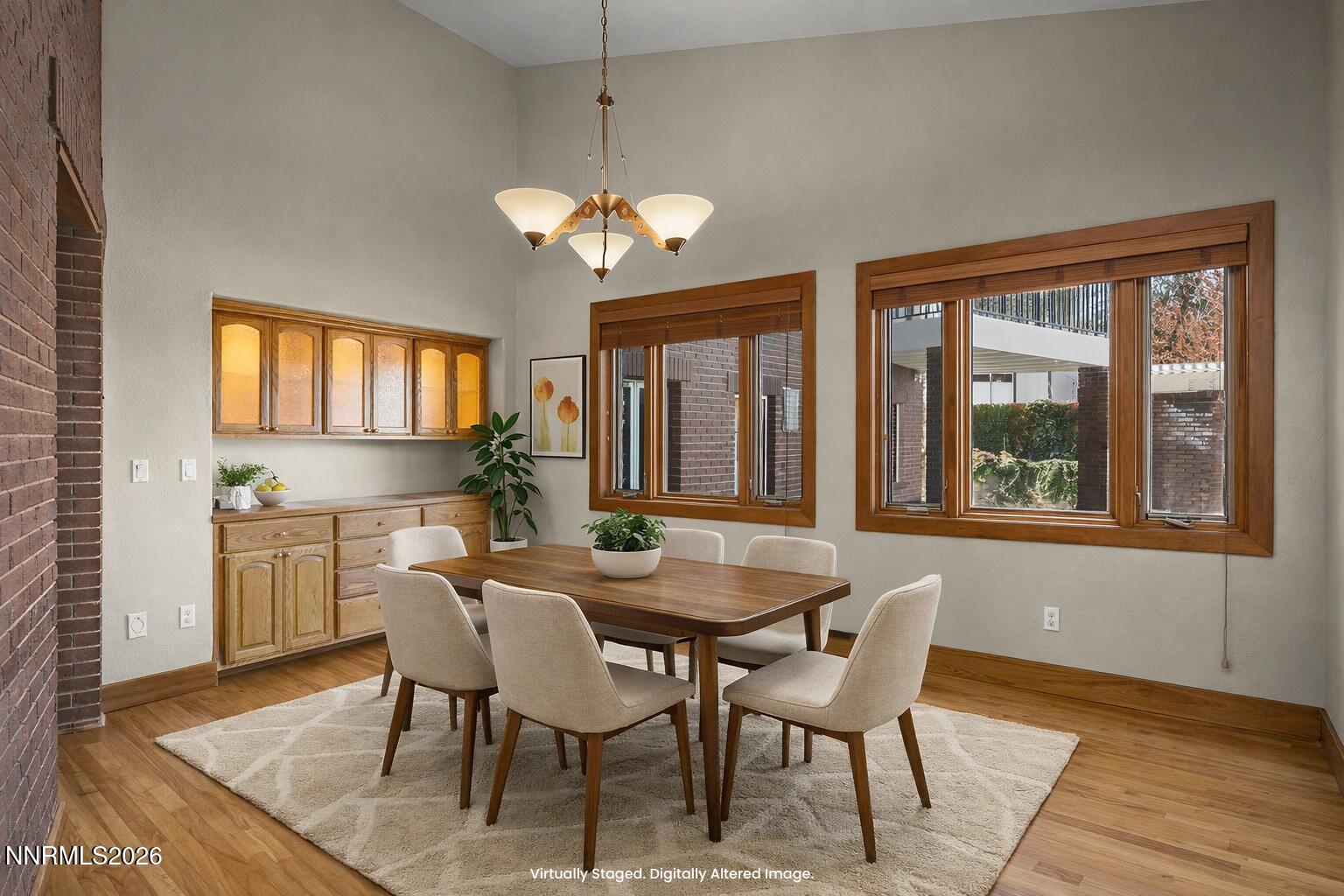 2425 Foley Way Reno, NV 89509 - Photo 24 of 73 a dining room with furniture a chandelier and wooden floor