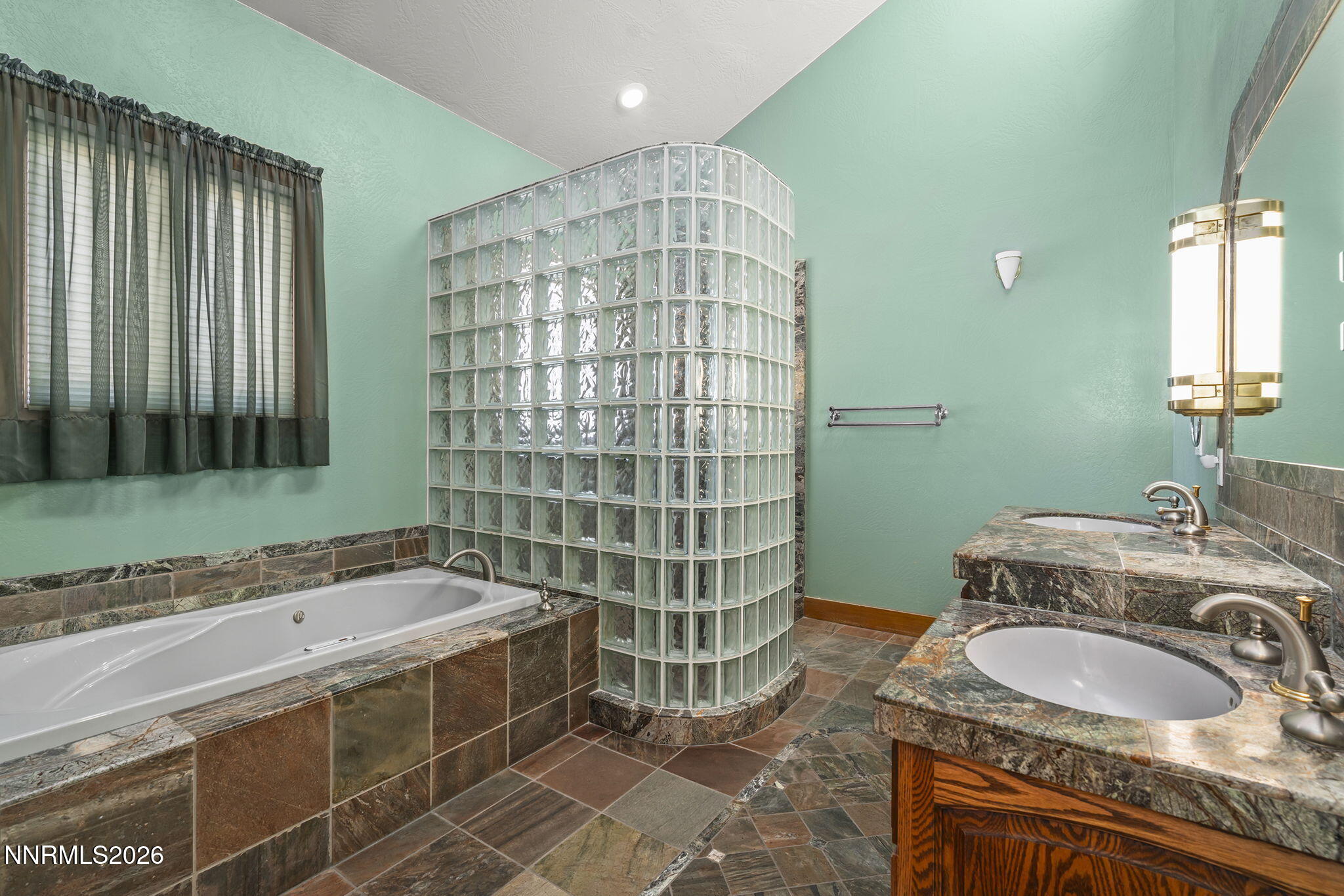 2425 Foley Way Reno, NV 89509 - Photo 33 of 73 a bathroom with a granite countertop sink and a mirror