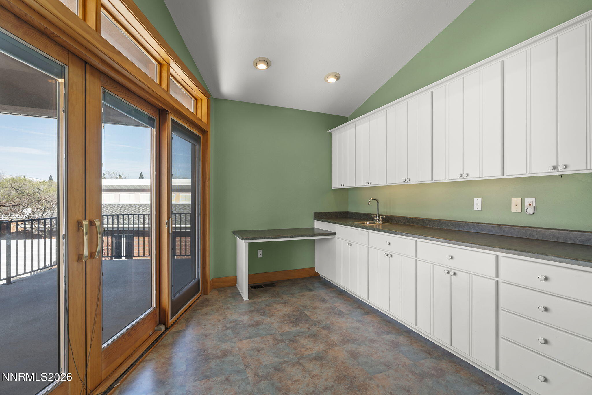 2425 Foley Way Reno, NV 89509 - Photo 50 of 73 a kitchen with granite countertop a sink and white cabinets