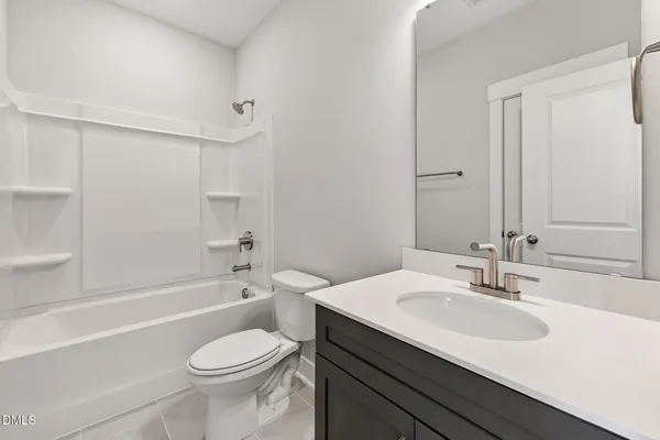 a white bath tub sitting next to a white toilet and sink