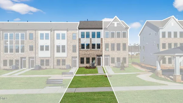 a front view of a residential apartment building with a yard