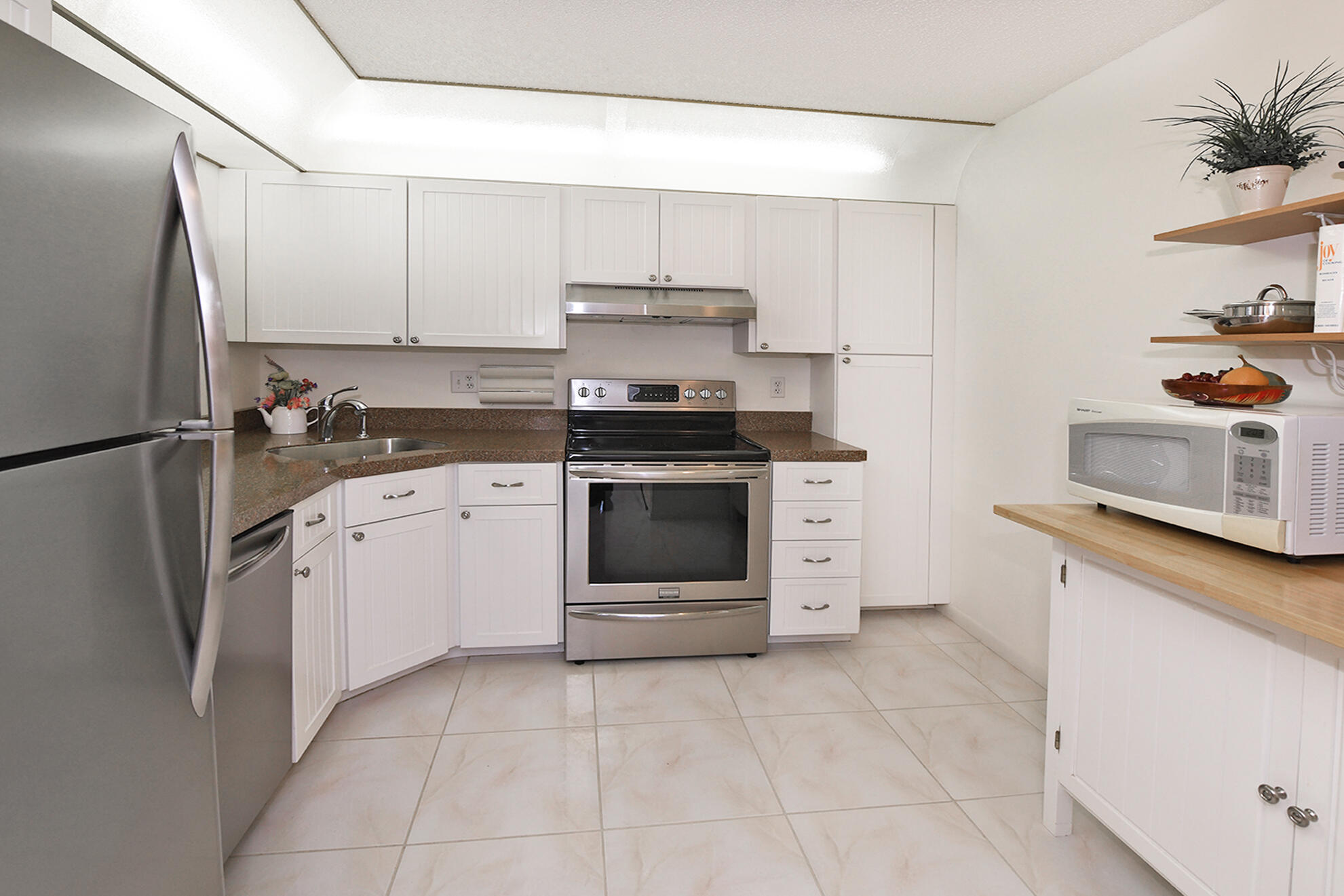 8541 Boca Glades Boulevard West, Unit A Boca Raton, FL 33434 - Photo 11 of 41 a kitchen with a stove sink and a refrigerator