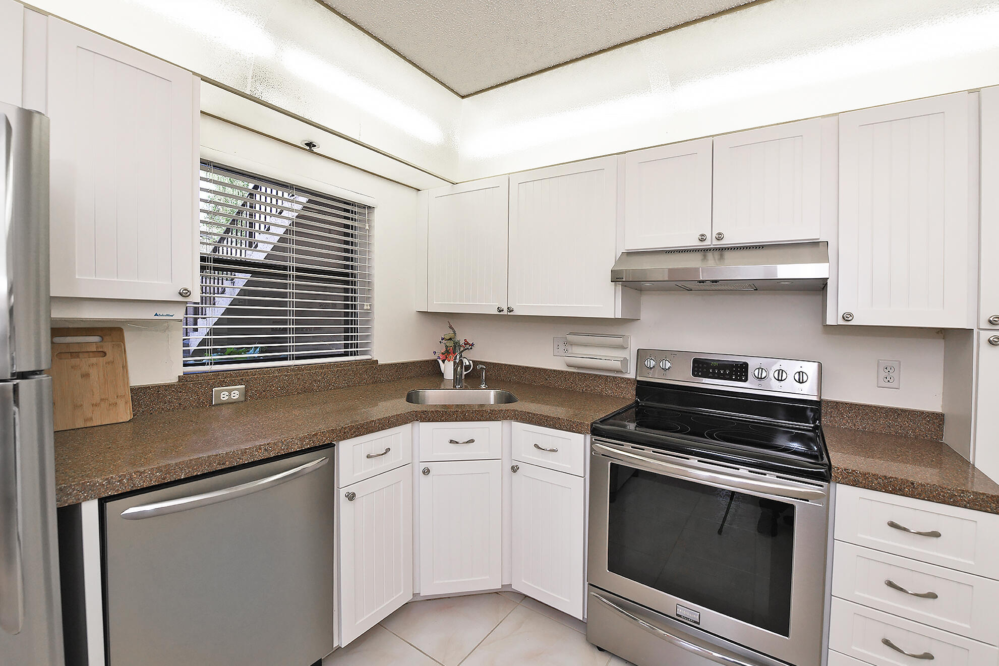 8541 Boca Glades Boulevard West, Unit A Boca Raton, FL 33434 - Photo 13 of 41 a kitchen with granite countertop white cabinets and white appliances