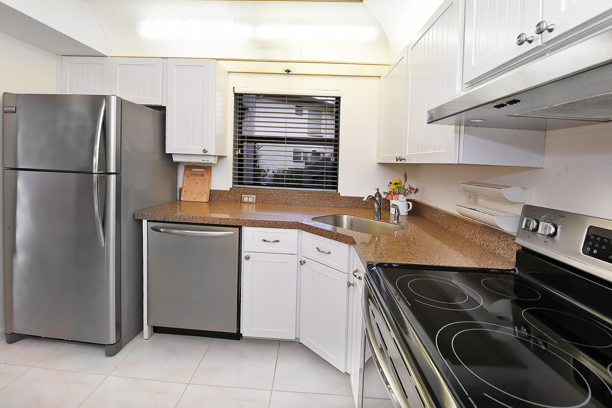 8541 Boca Glades Boulevard West, Unit A Boca Raton, FL 33434 - Photo 14 of 41 a kitchen with a sink stove and refrigerator