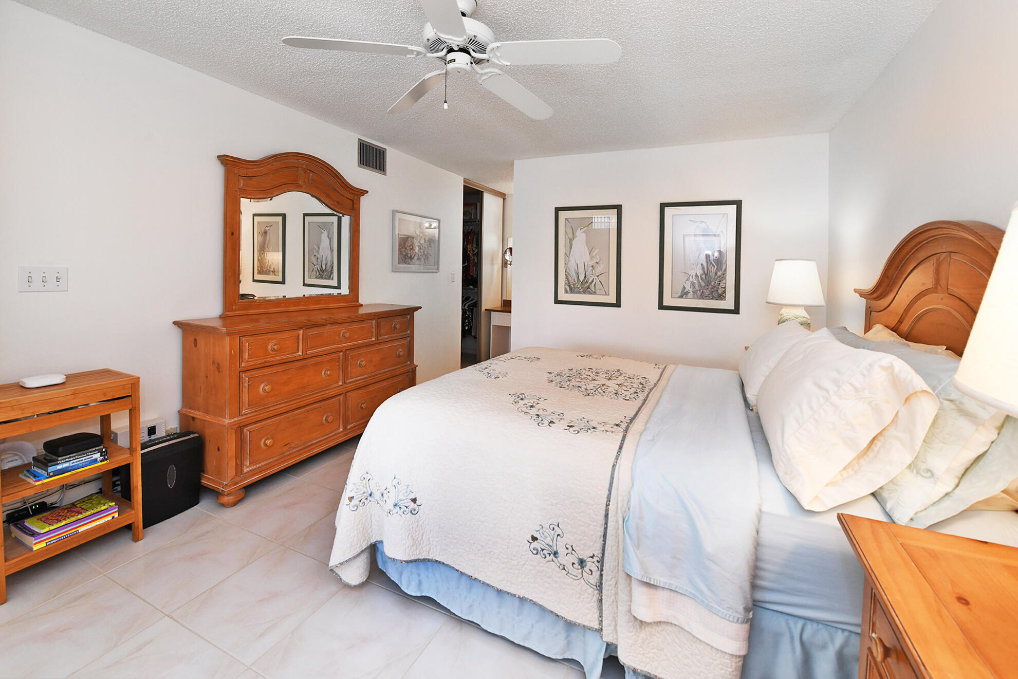 8541 Boca Glades Boulevard West, Unit A Boca Raton, FL 33434 - Photo 15 of 41 a bedroom with a bed and wooden floor