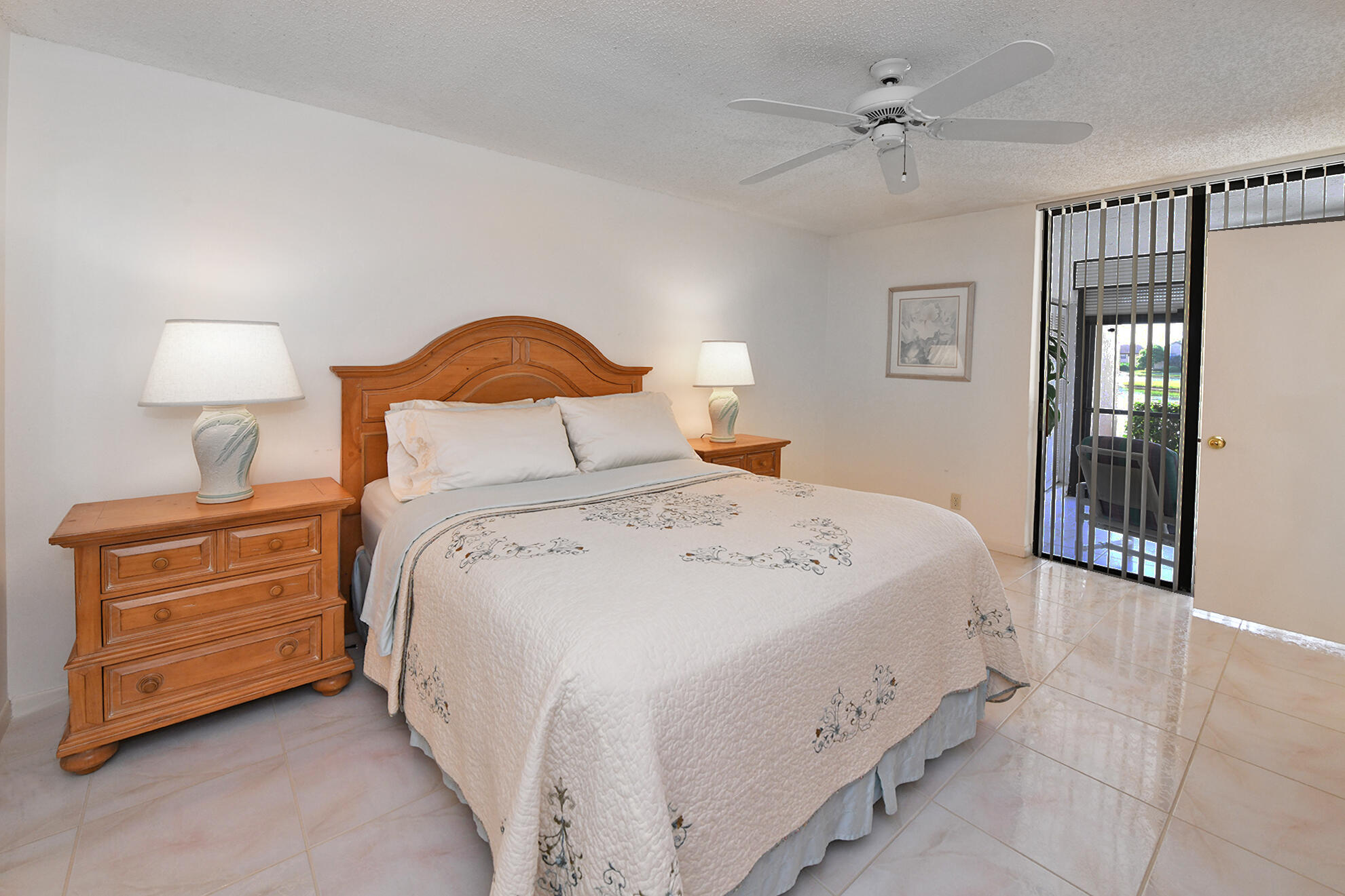 8541 Boca Glades Boulevard West, Unit A Boca Raton, FL 33434 - Photo 17 of 41 a bedroom with a bed and a night stand