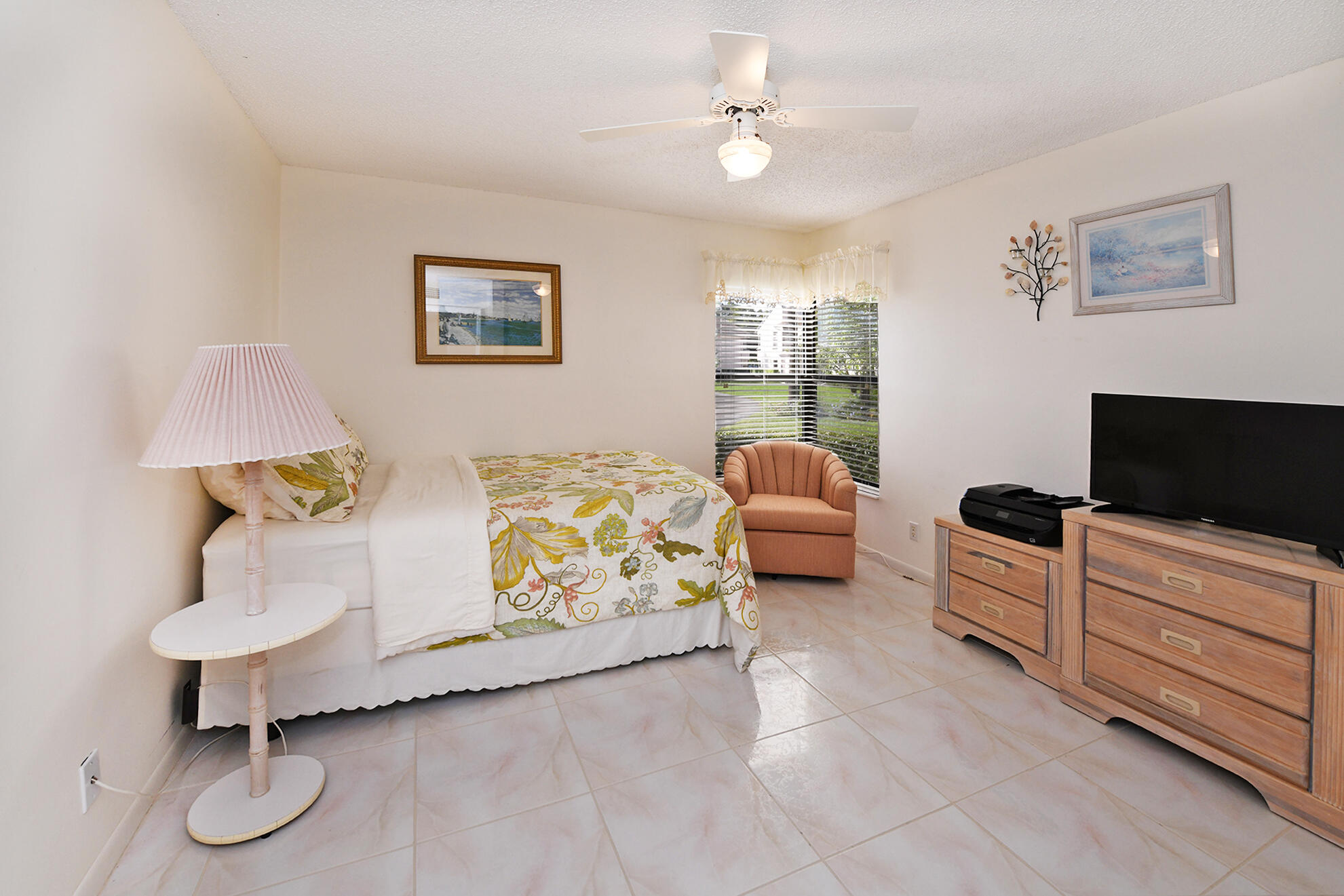 8541 Boca Glades Boulevard West, Unit A Boca Raton, FL 33434 - Photo 20 of 41 a spacious bedroom with a bed and a flat screen tv