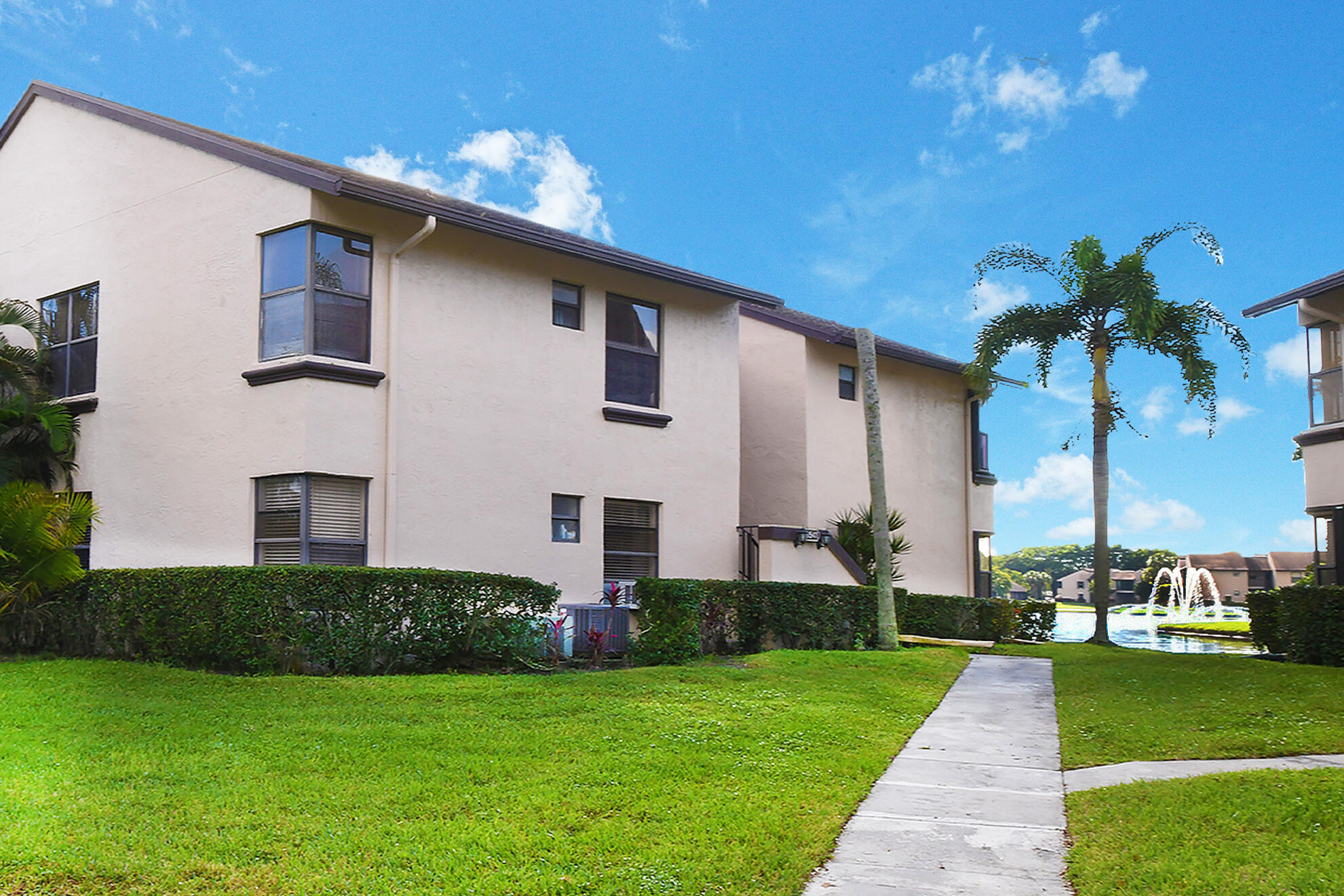 8541 Boca Glades Boulevard West, Unit A Boca Raton, FL 33434 - Photo 2 of 41 a front view of a house with garden