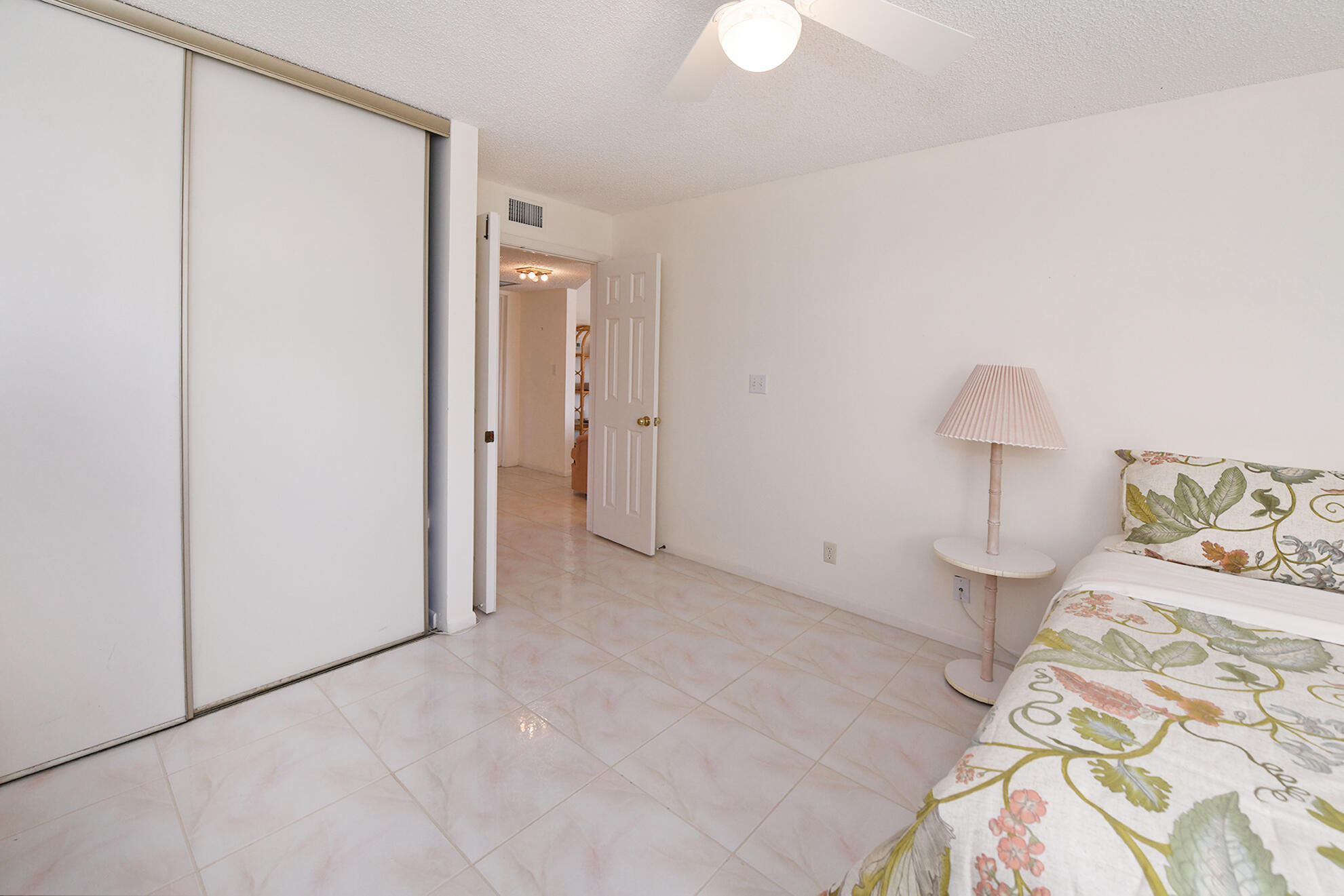 8541 Boca Glades Boulevard West, Unit A Boca Raton, FL 33434 - Photo 21 of 41 a view of a bedroom with a bed and a lamp