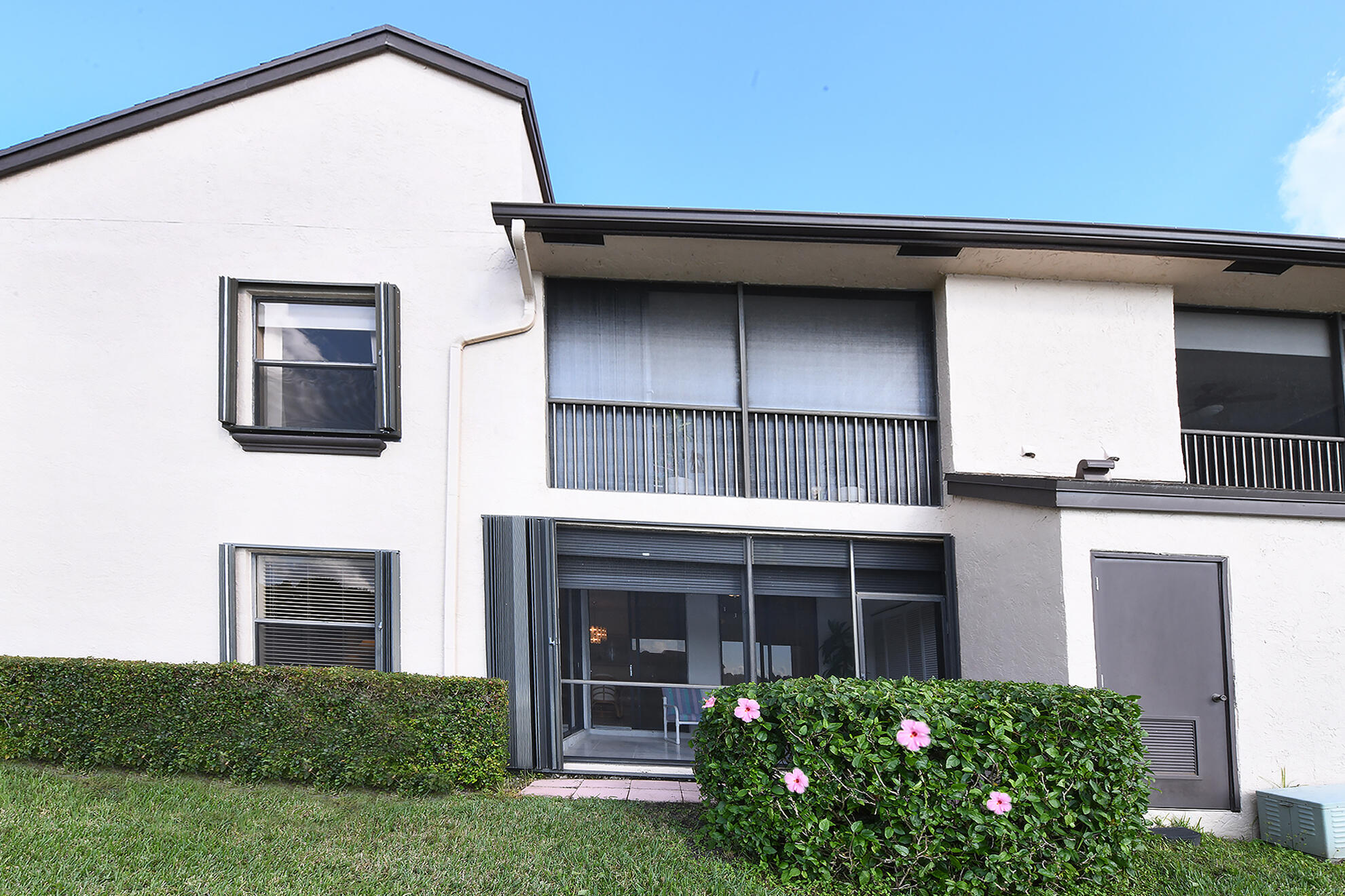 8541 Boca Glades Boulevard West, Unit A Boca Raton, FL 33434 - Photo 26 of 41 a view of front door and potted plants