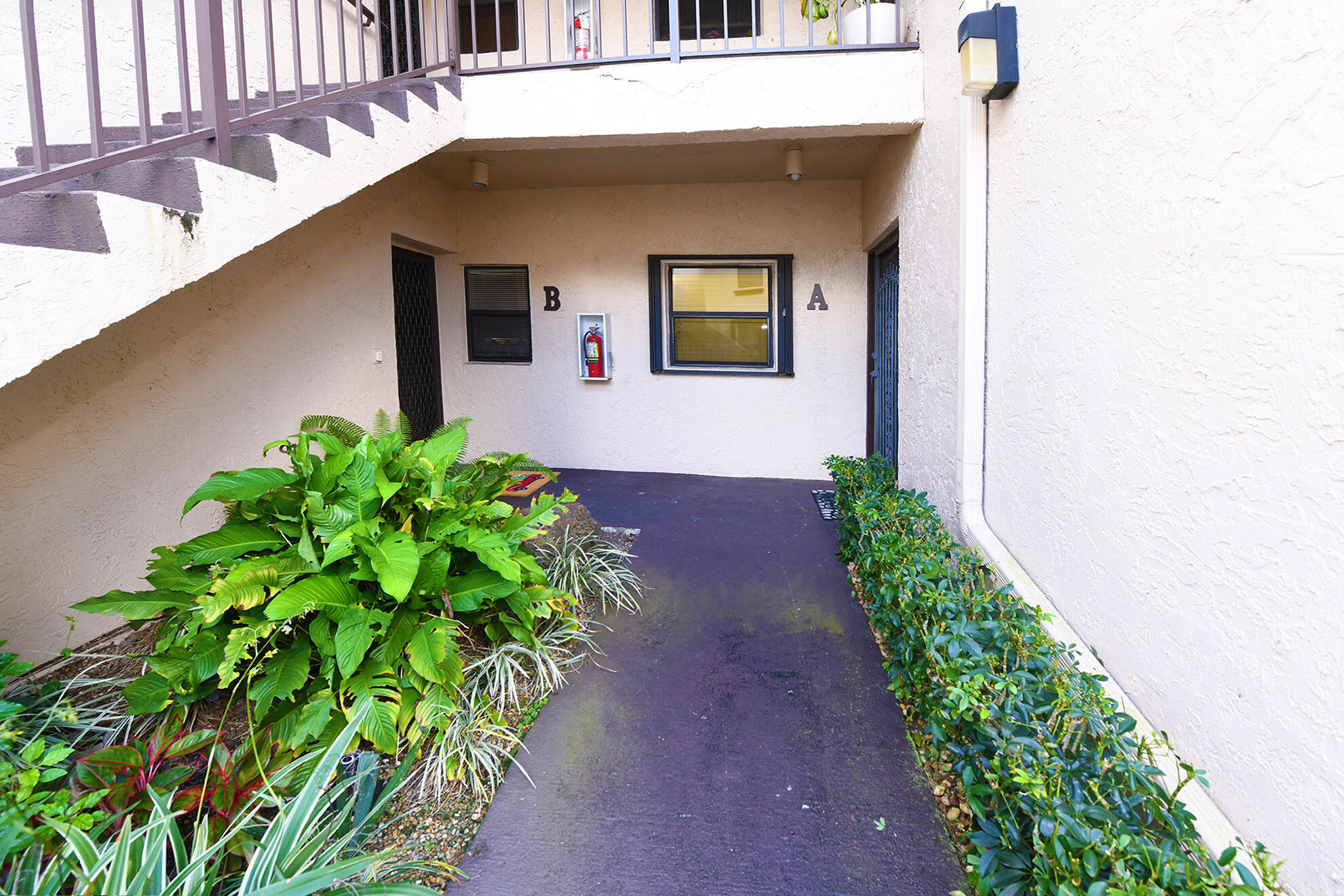 8541 Boca Glades Boulevard West, Unit A Boca Raton, FL 33434 - Photo 3 of 41 a front view of a house with a yard