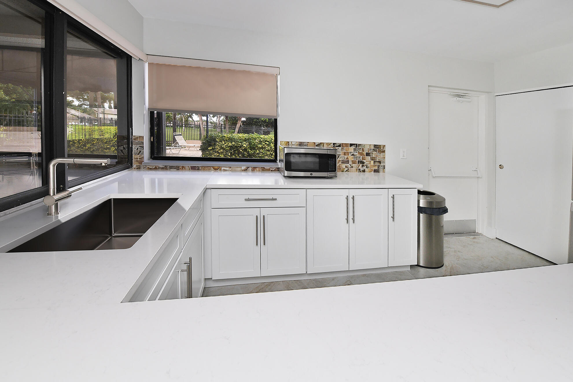 8541 Boca Glades Boulevard West, Unit A Boca Raton, FL 33434 - Photo 30 of 41 a kitchen that has a sink and a stove