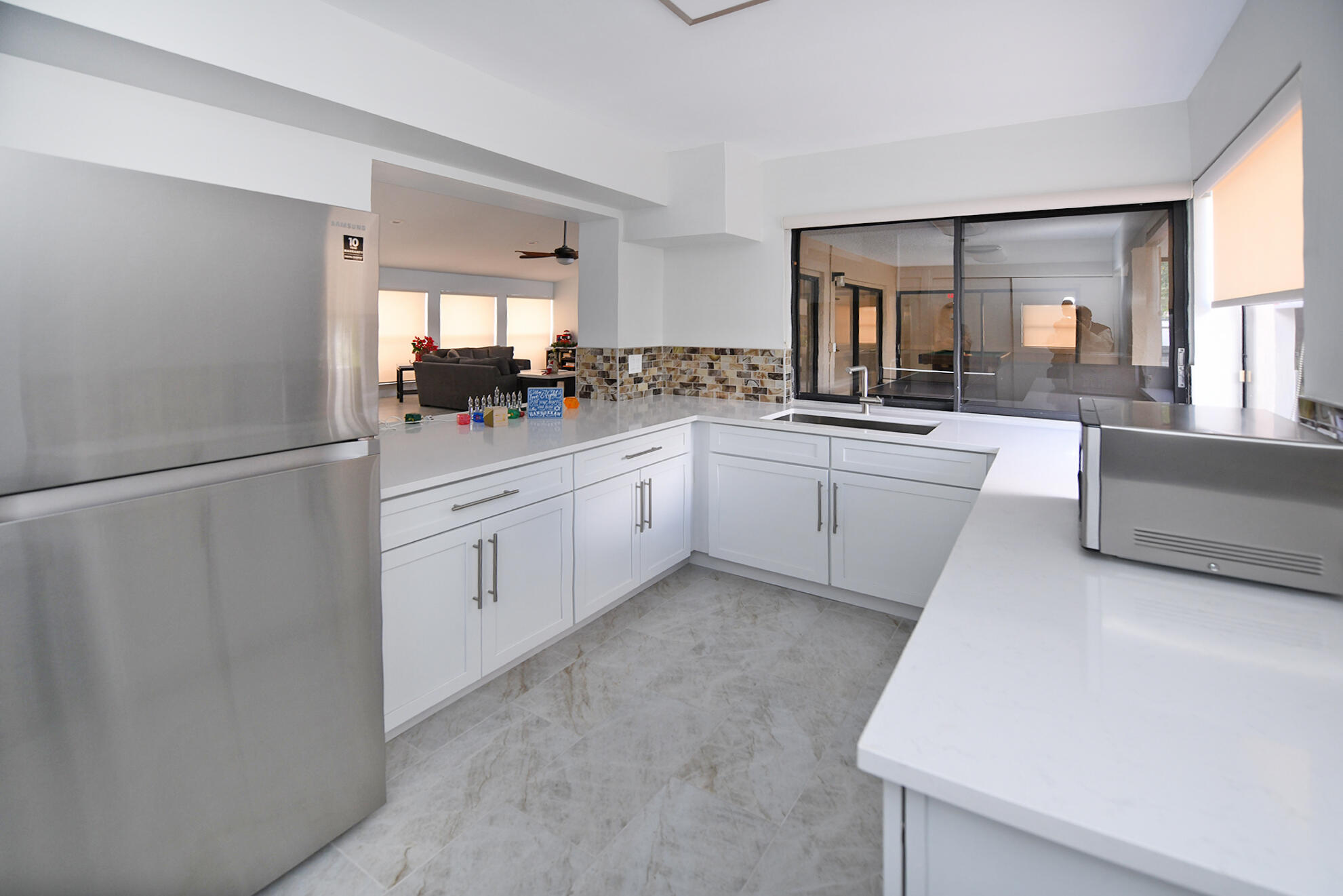 8541 Boca Glades Boulevard West, Unit A Boca Raton, FL 33434 - Photo 31 of 41 a large white kitchen with cabinets a sink and dishwasher