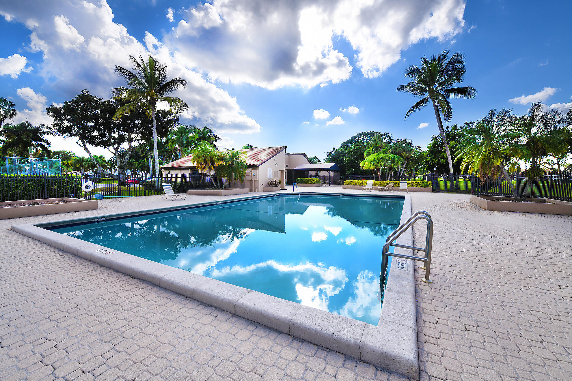 8541 Boca Glades Boulevard West, Unit A Boca Raton, FL 33434 - Photo 33 of 41 a view of a swimming pool with a yard and plants