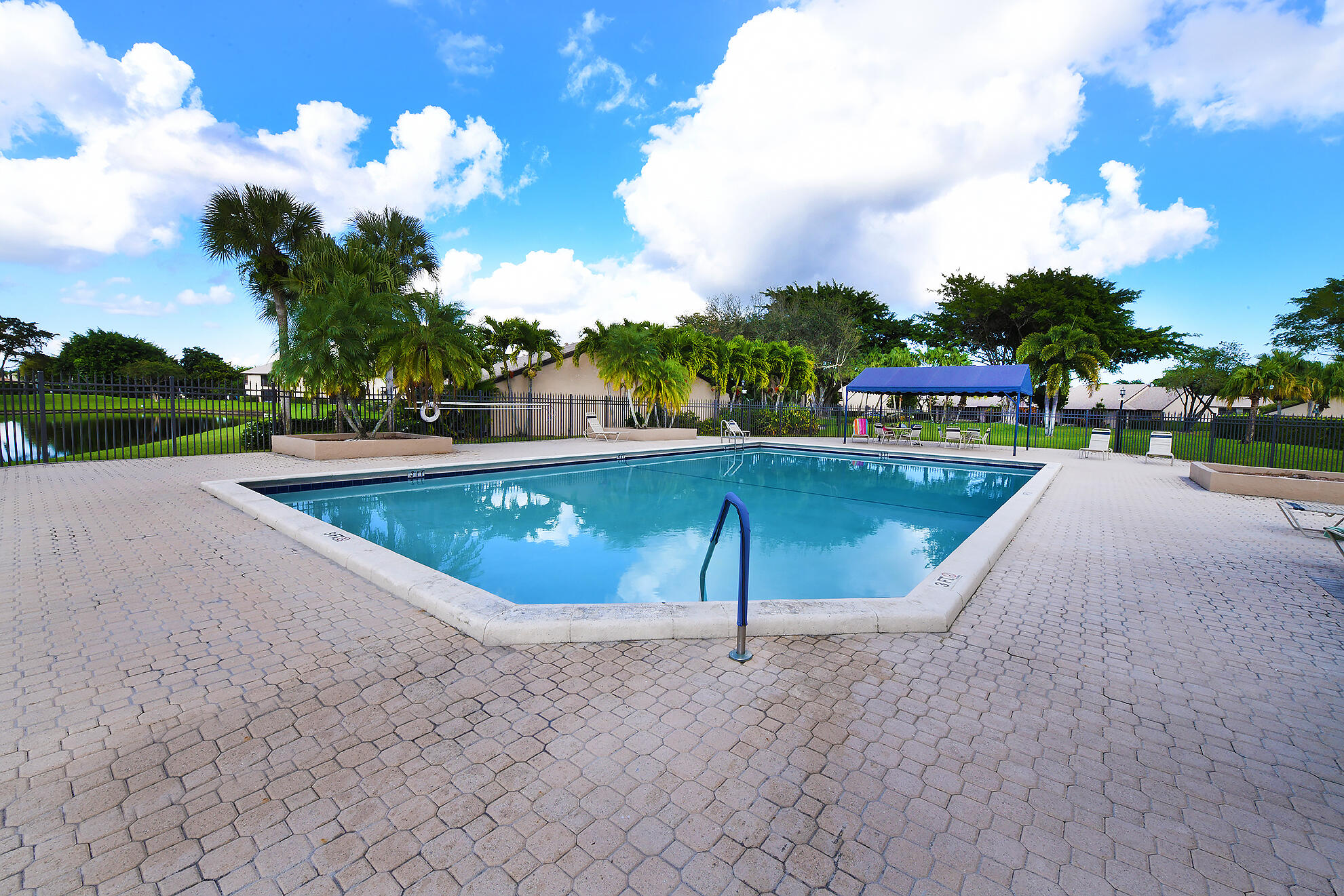 8541 Boca Glades Boulevard West, Unit A Boca Raton, FL 33434 - Photo 35 of 41 a view of a swimming pool with a yard
