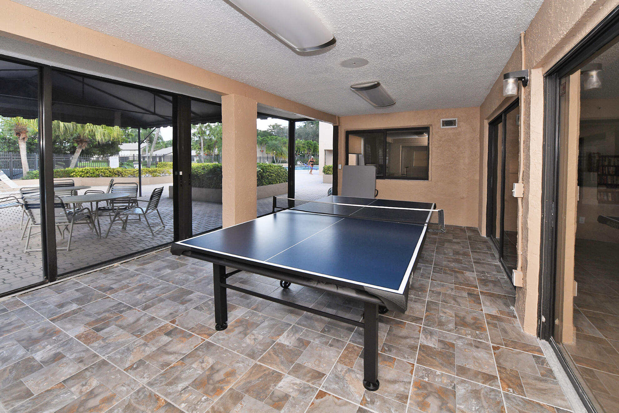 8541 Boca Glades Boulevard West, Unit A Boca Raton, FL 33434 - Photo 39 of 41 a room with lawn chairs and a large window