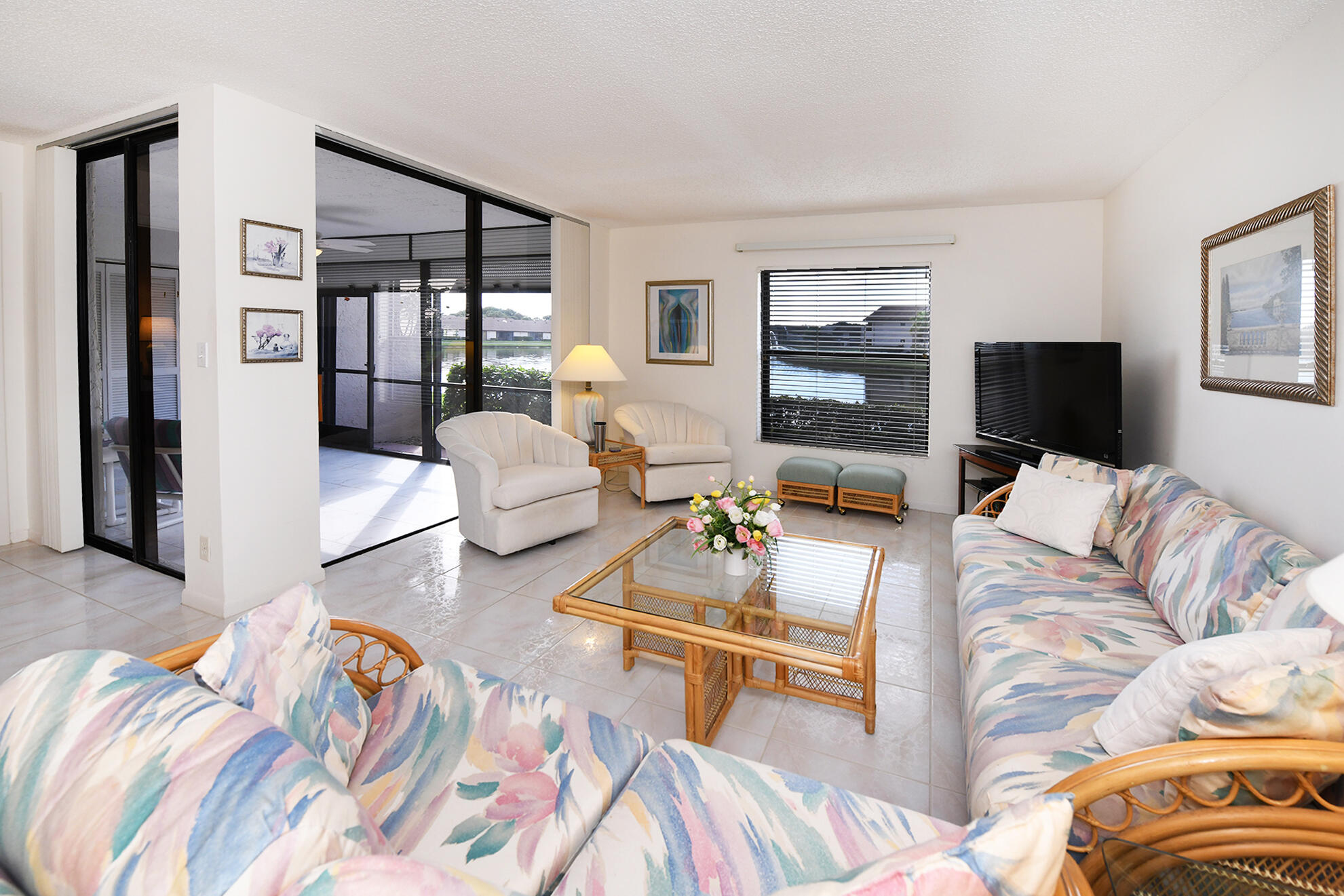 8541 Boca Glades Boulevard West, Unit A Boca Raton, FL 33434 - Photo 5 of 41 a living room with furniture and a flat screen tv