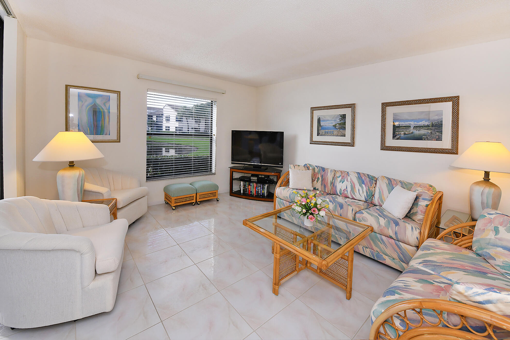 8541 Boca Glades Boulevard West, Unit A Boca Raton, FL 33434 - Photo 6 of 41 a living room with furniture a flat screen tv and a window