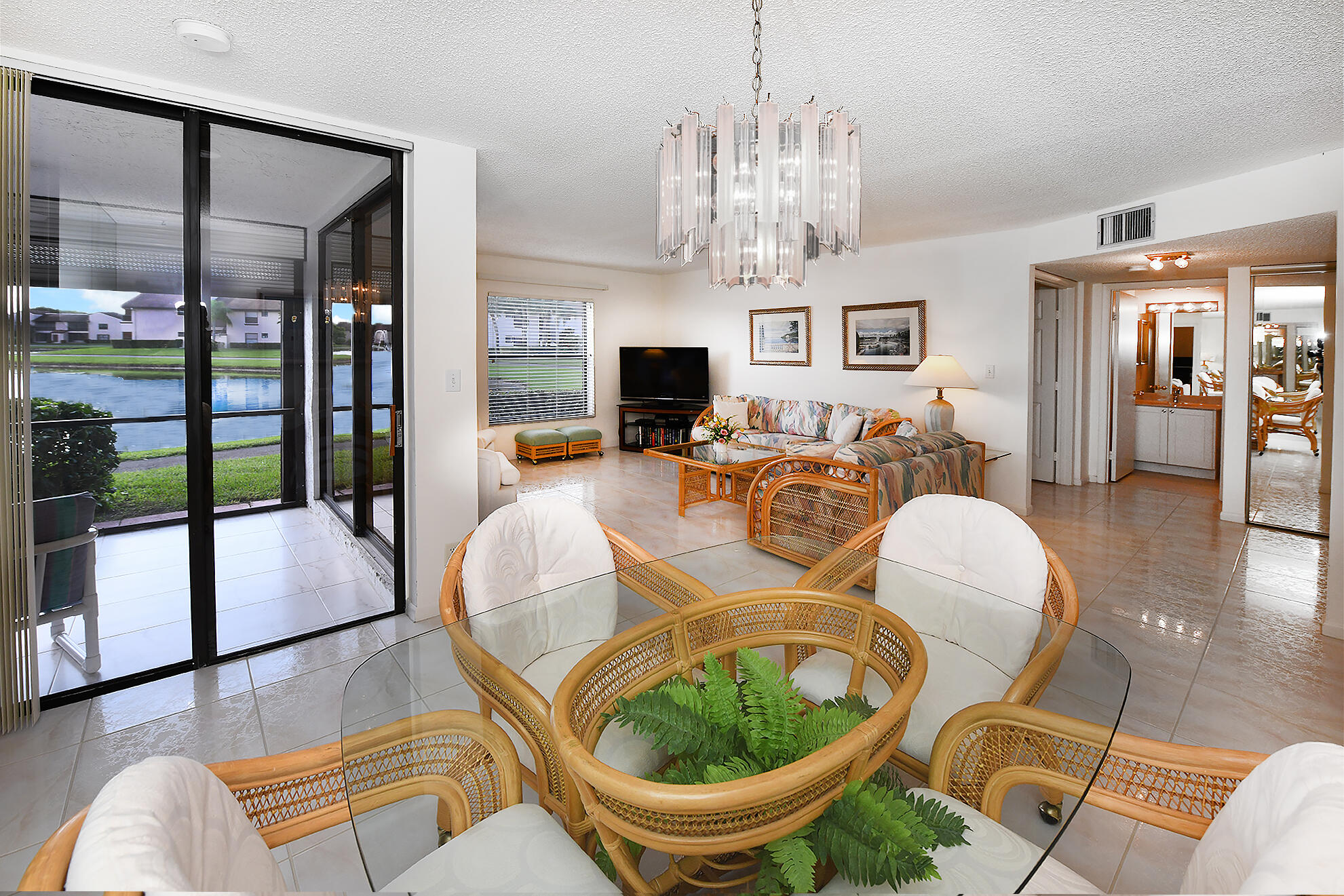 8541 Boca Glades Boulevard West, Unit A Boca Raton, FL 33434 - Photo 10 of 41 a living room with fireplace furniture and a chandelier